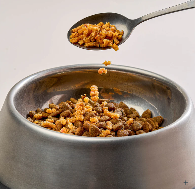 Chicken Sprinkles spooned into a dog bowl