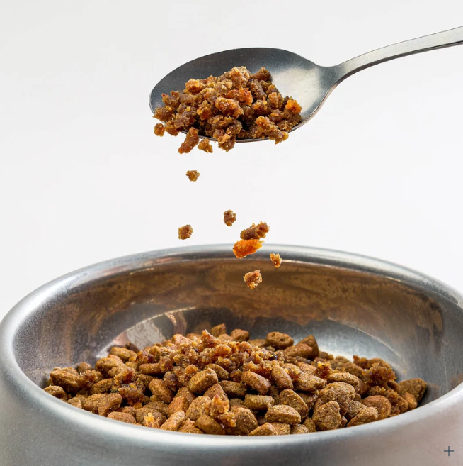 Pork Sprinkles spooned into a dog bowl